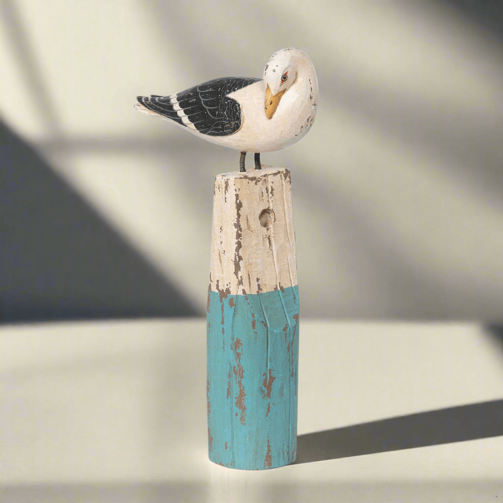 Vintage nautical seagull figurine on weathered buoy, handcrafted beechwood with sea-washed hues of turquoise and ivory.