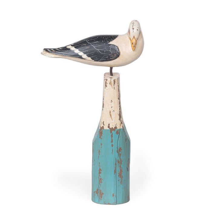 Vintage nautical seagull figurine perched on turquoise buoy, handcrafted from beechwood with a distressed ocean-inspired finish.