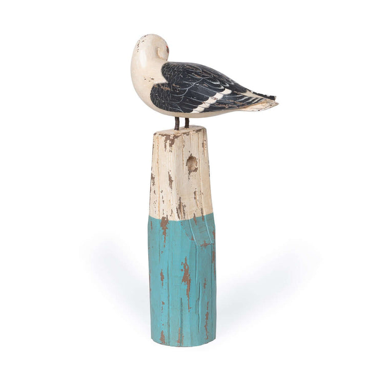Vintage nautical seagull figurine on weathered buoy in ocean hues, handcrafted from beechwood. Coastal decor, distressed finish.