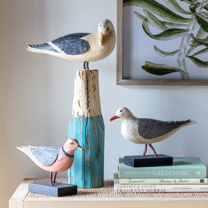 Vintage nautical seagull figurine on weathered buoy, handcrafted in sea-washed turquoise with a distressed finish, displayed on a shelf.