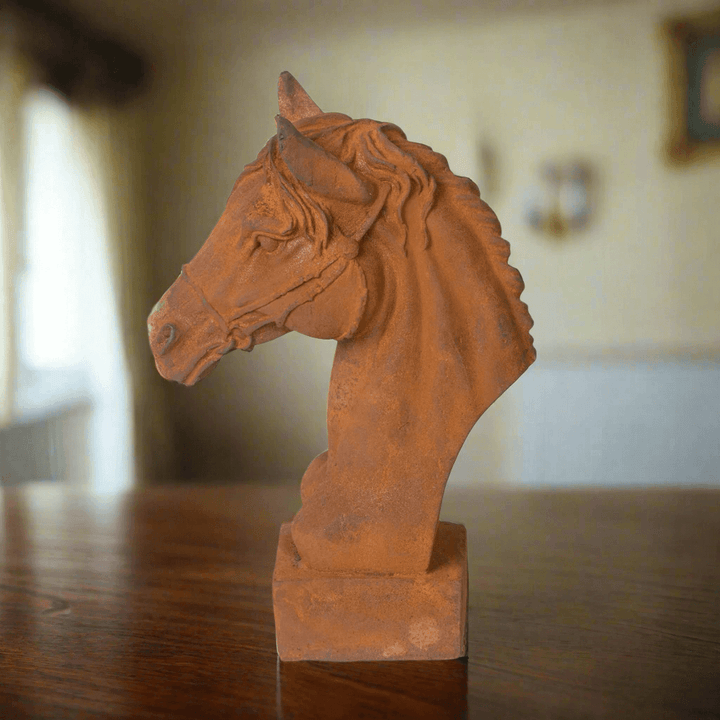 Aged cast iron horse head sculpture with rust patina, perfect for equestrian decor and adding elegance to classic interiors.