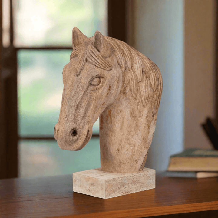 Rustic wooden horse head sculpture on table, perfect for farmhouse decor, highlighting craftsmanship and natural wood details.