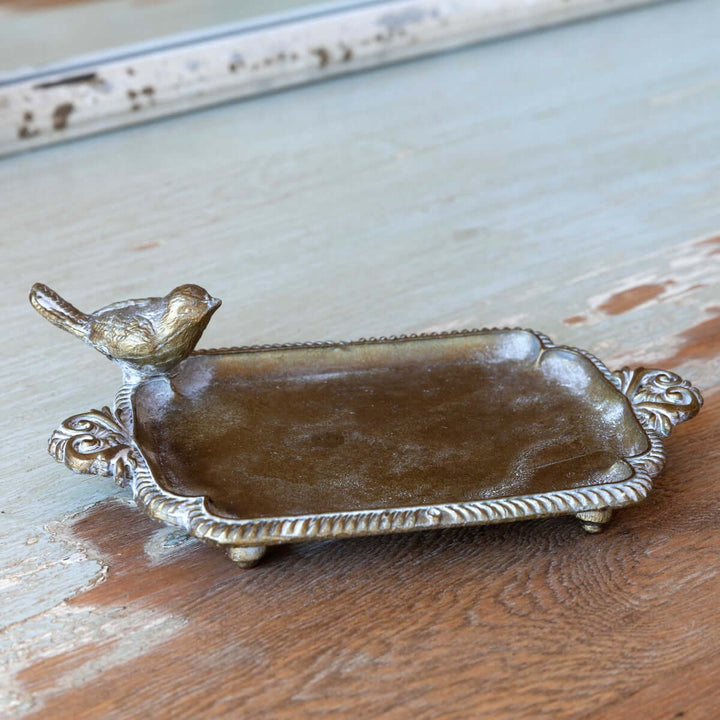 Antique brass bird soap dish with vintage-inspired patina, evoking charm and nostalgia of cozy cottage bathrooms and farmhouse kitchens.