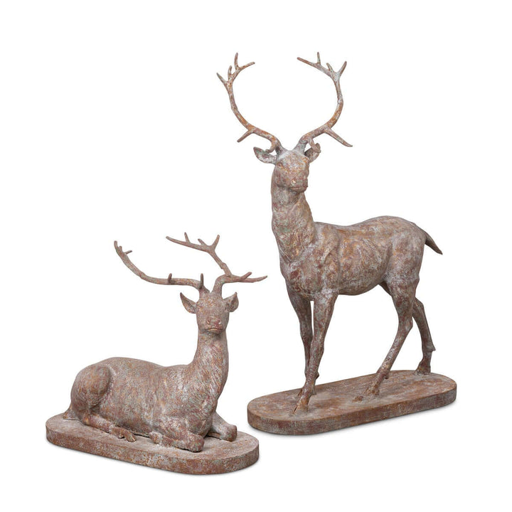 Antique style cast iron deer statues set featuring a standing stag and reclining doe, perfect for adding elegance to outdoor spaces.