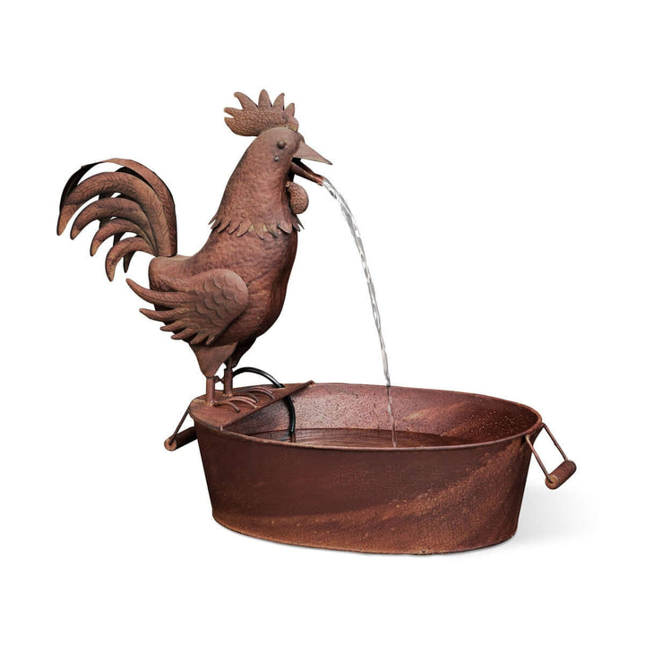 Vintage farmhouse rooster fountain crafted from rusted metal with water trickling, celebrating rural artistry and timeless design.