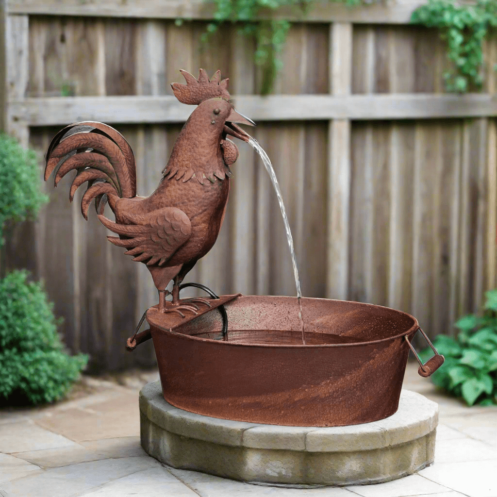 Vintage Farmhouse Rooster Fountain made of aged rusted metal in a garden setting