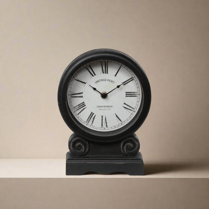 Antique-style mantel clock with Roman numerals and faded ivory dial on black distressed finish for vintage home decor.