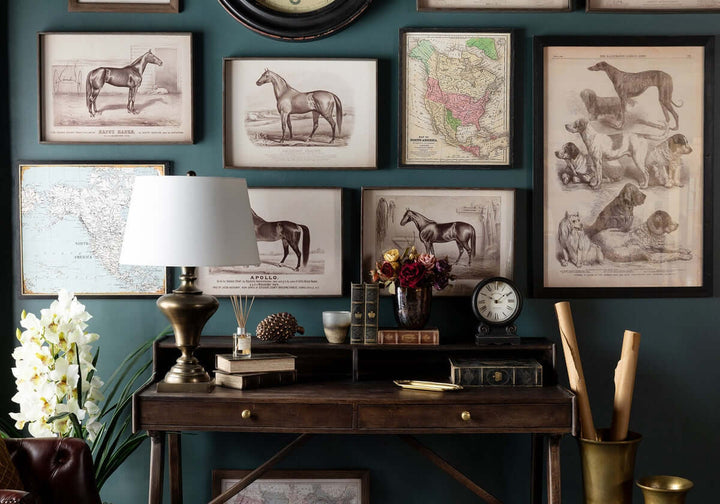 Vintage-themed home interior with antique-style Roman numeral mantel clock, horse and dog prints, and classic wooden desk decor.