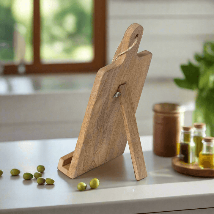 Rustic wooden farmhouse cookbook holder with cutting board design on a kitchen counter.