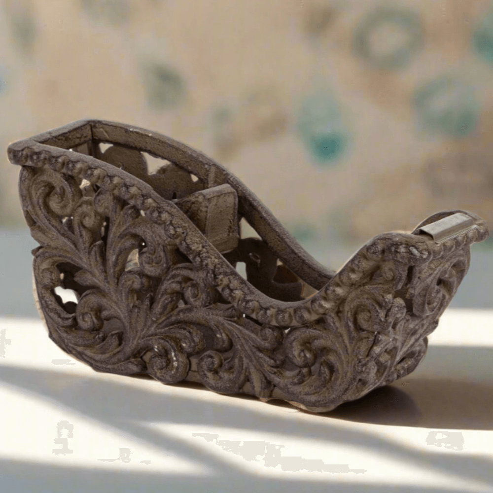 Ornate tape dispenser with acanthus leaf design, antique-inspired metal finish, elegant addition to desk decor.