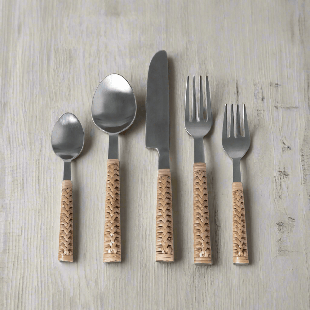 Handwoven bamboo and stainless steel cutlery set on wooden table, showcasing vintage-inspired design and craftsmanship.