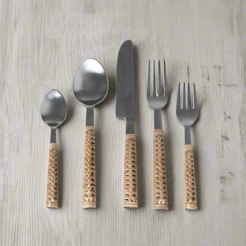 Handwoven bamboo and stainless steel cutlery set on wooden table, showcasing vintage-inspired design and craftsmanship.