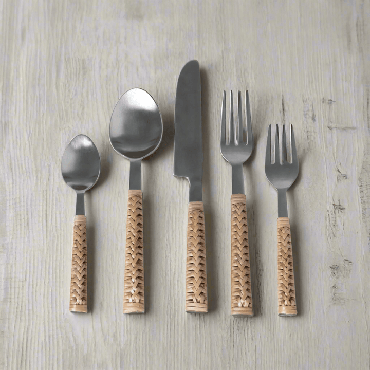 Handwoven bamboo and stainless steel cutlery set on wooden table, showcasing vintage-inspired design and craftsmanship.