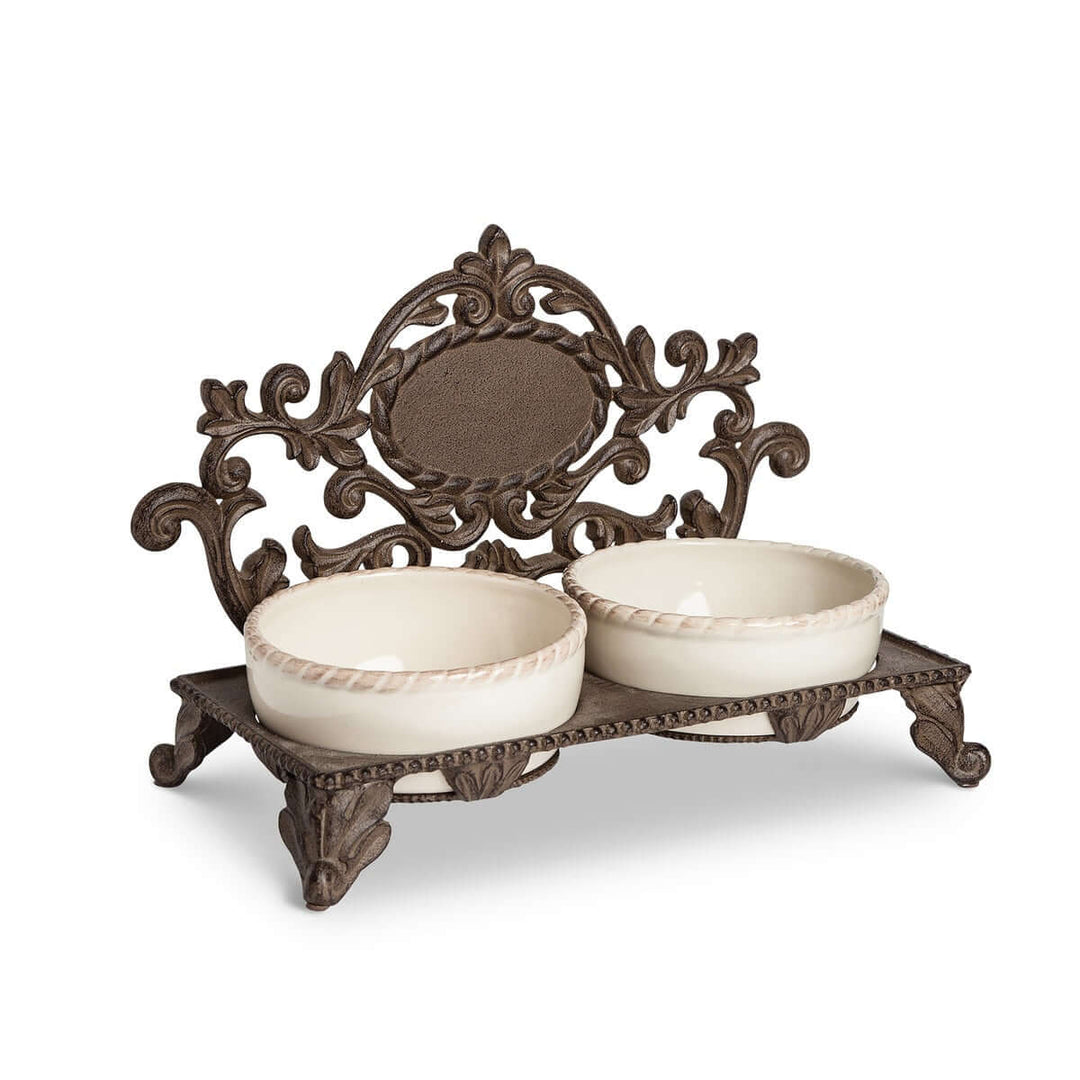 Vintage cast iron pet feeder with dual ceramic bowls, ornate design. Ornate elevated pet feeder for stylish pet dining.