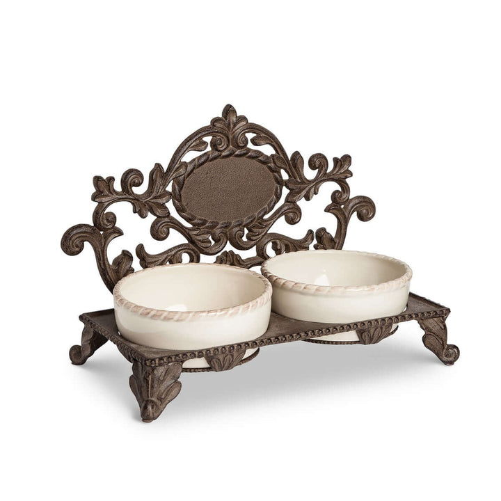 Vintage cast iron pet feeder with dual ceramic bowls, ornate design. Ornate elevated pet feeder for stylish pet dining.