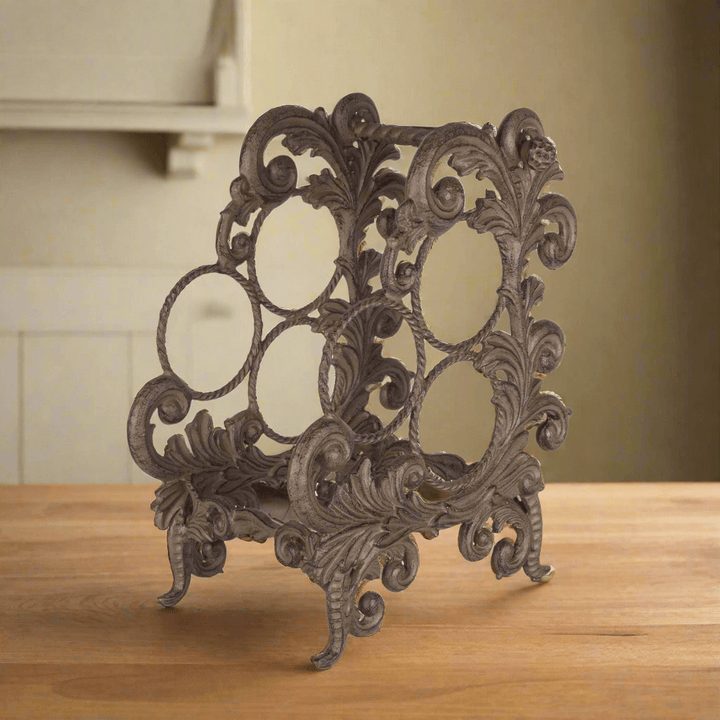 Vintage Acanthus Leaf Cast Aluminum Wine Rack with ornate design on wooden table, antique bronze finish, European elegance