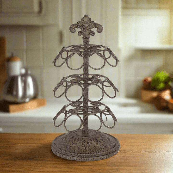 Vintage Acanthus Coffee Pod Carousel Organizer with ornate acanthus leaf motif and antique bronze finish on a kitchen counter.
