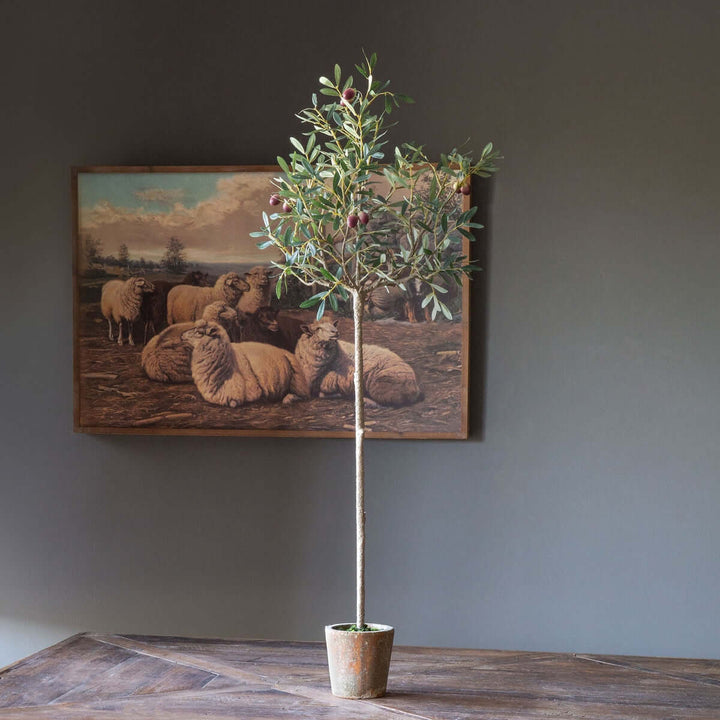 Faux olive tree topiary in vintage pot, adding Mediterranean elegance to home decor with lifelike silvery-green leaves and textured trunk.
