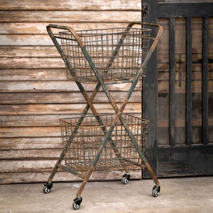 Vintage rolling metal market cart with double baskets, farmhouse style, weathered metal finish, adds rustic charm.