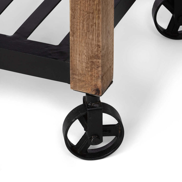 Close-up of vintage garden cart's rustic mango wood with black iron wheel, highlighting craftsmanship and durability.