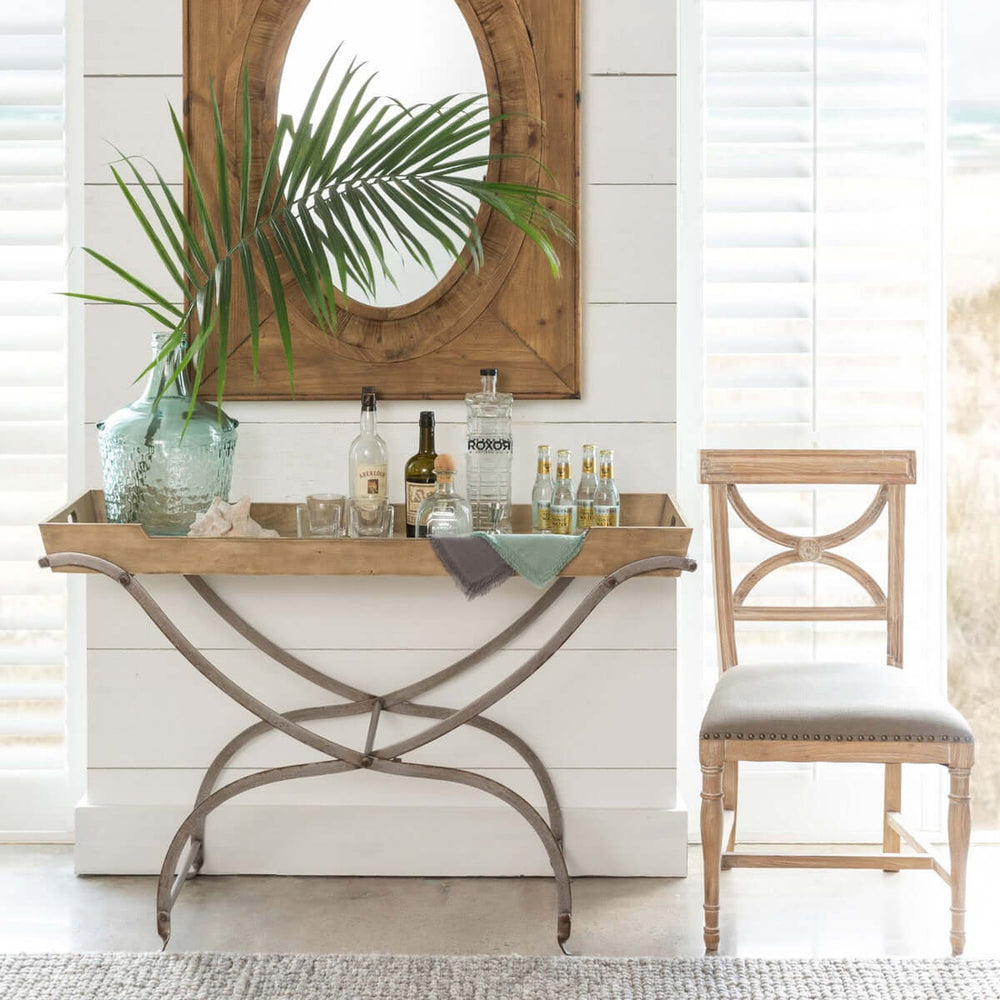 Vintage Wooden Tray Console Table with decorative items, chair, and mirror in a coastal cottage-style room.