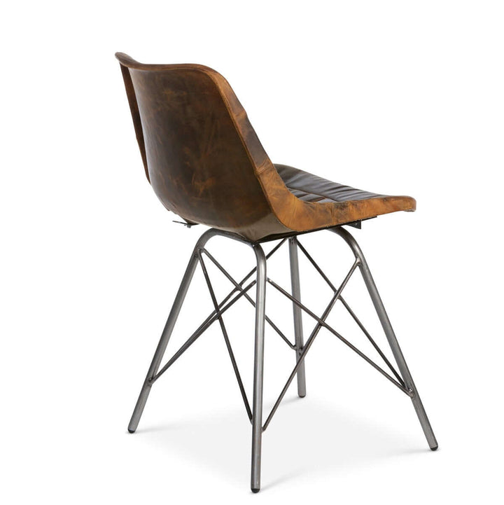 Vintage industrial desk chair with aged leather seat and metal legs, offering rustic charm and timeless style for any workspace.