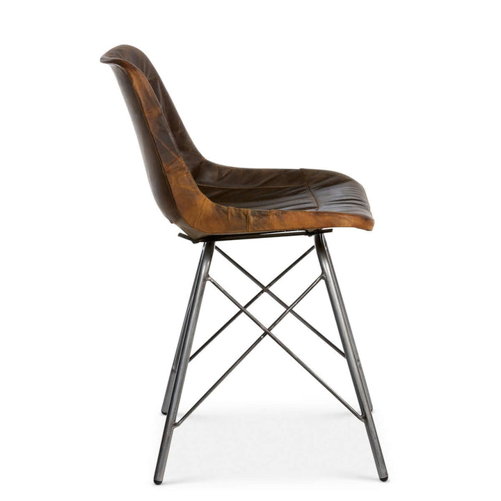 Vintage industrial desk chair with aged leather seat and metal legs, showcasing distressed craftsmanship and character.