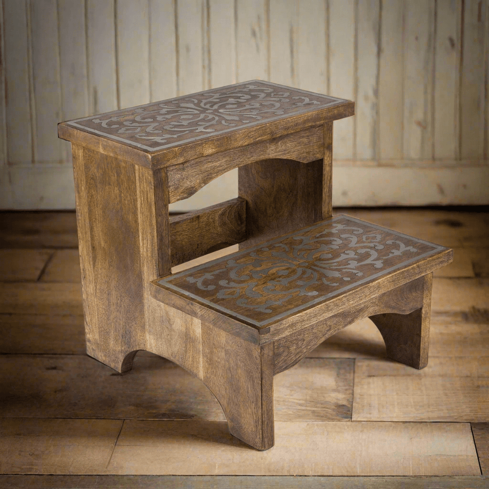 Wooden step stool with decorative metal inlay, handmade from mango wood, featuring intricate scrollwork design. Two-step vintage style.