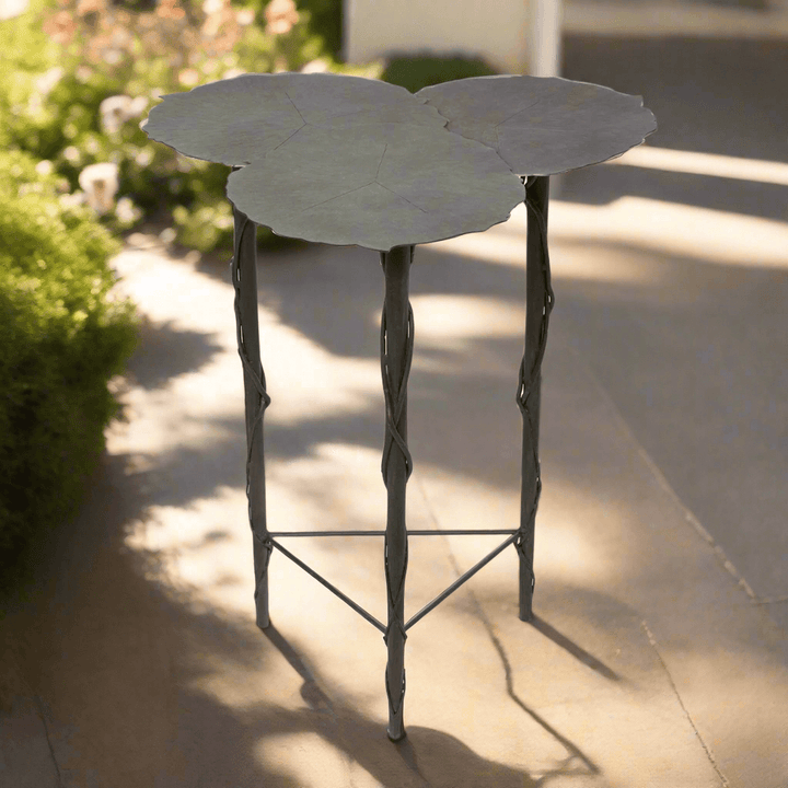 Lily Pad Side Table with aged patina, outdoor iron accent inspired by nature, featuring sculptural, veined overlapping tops.