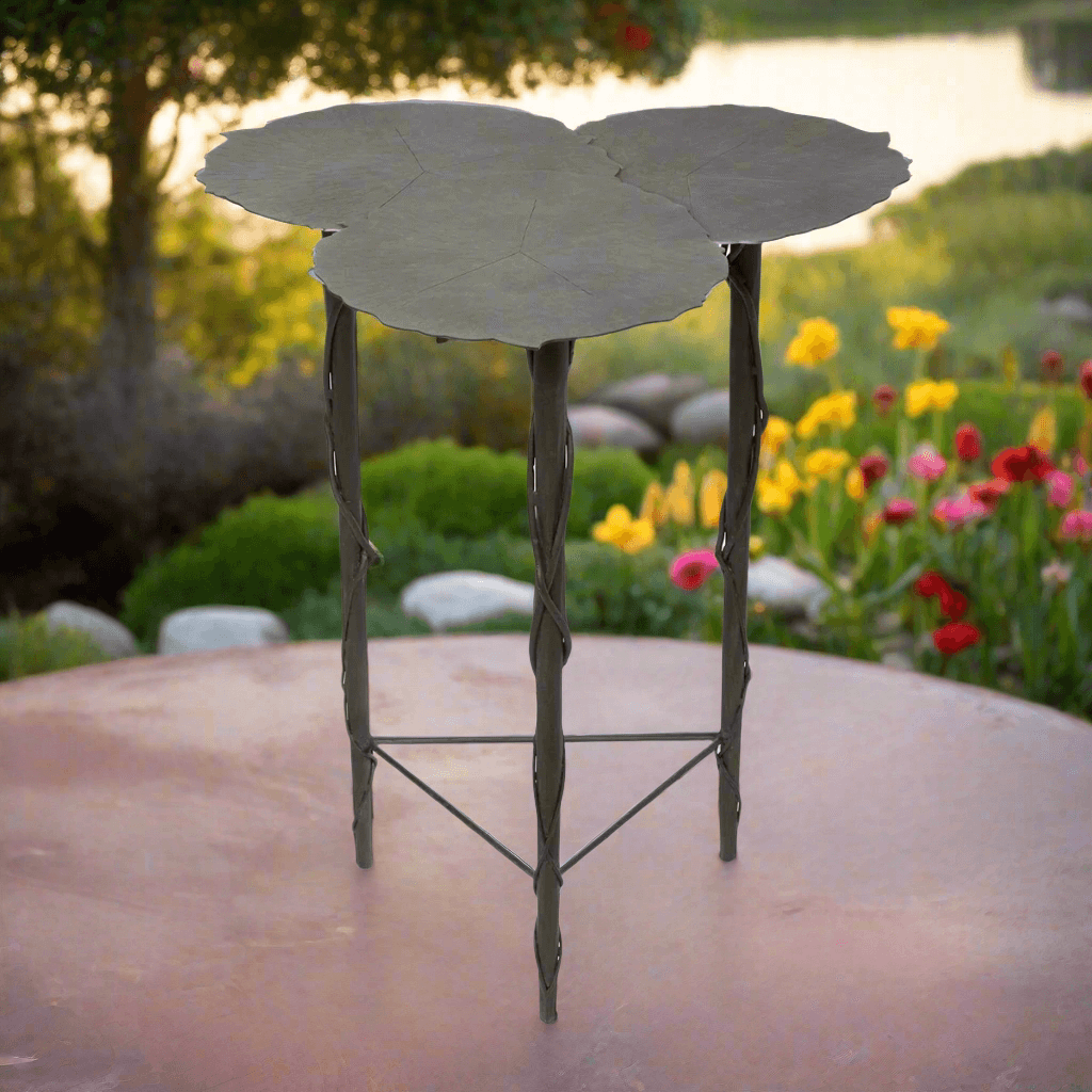 Lily Pad Side Table in garden setting, iron accent, aged patina, three overlapping tops resembling veined lily pads.