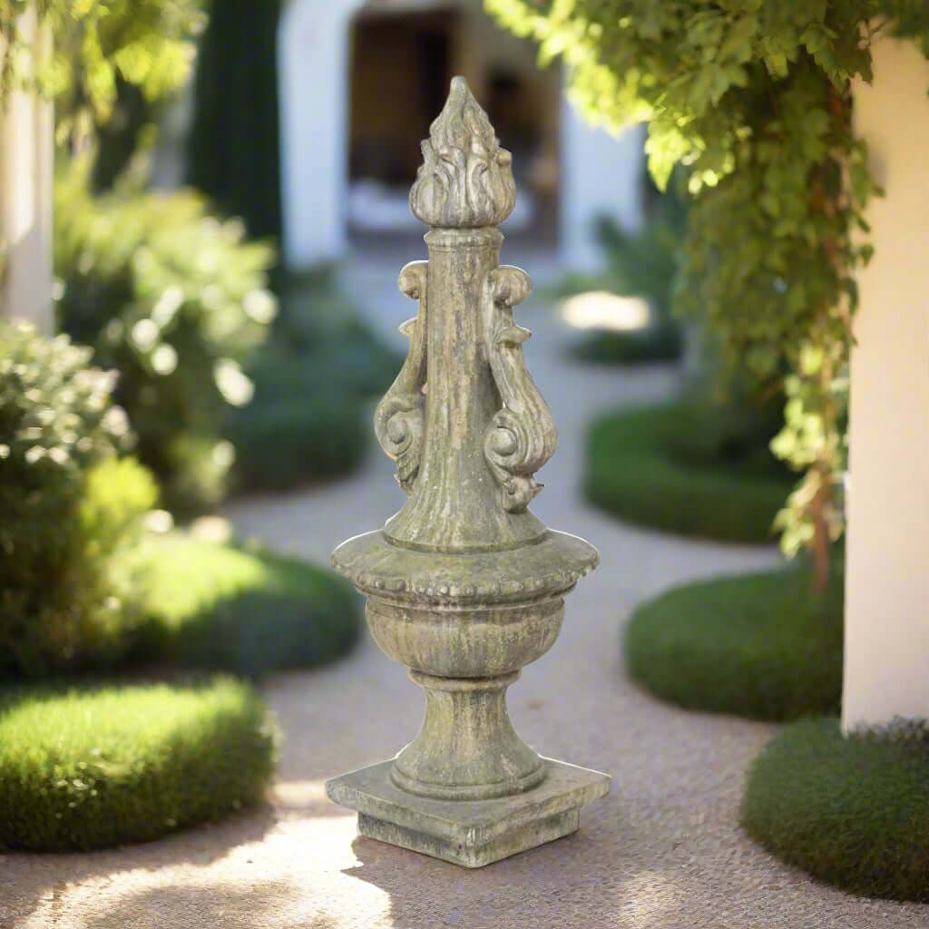 Antique Grecian Garden Torch Statue with weathered finish in lush garden setting.