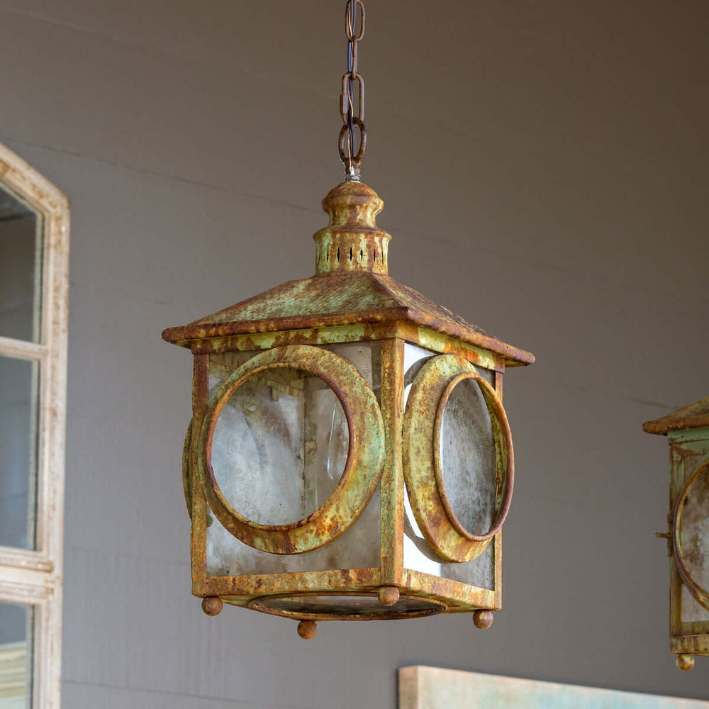Rustic aged metal lantern pendant with coastal design, featuring a weathered finish and old-world charm. Ideal for vintage decor.