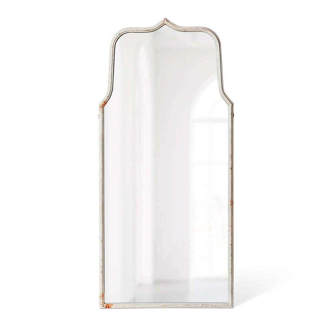 French Country arch mirror with distressed white frame, reflecting elegance and vintage charm, perfect for country-style decor.