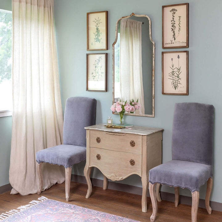 Elegant French Country arch mirror with distressed white frame in a vintage-inspired room, adding charm and sophistication.