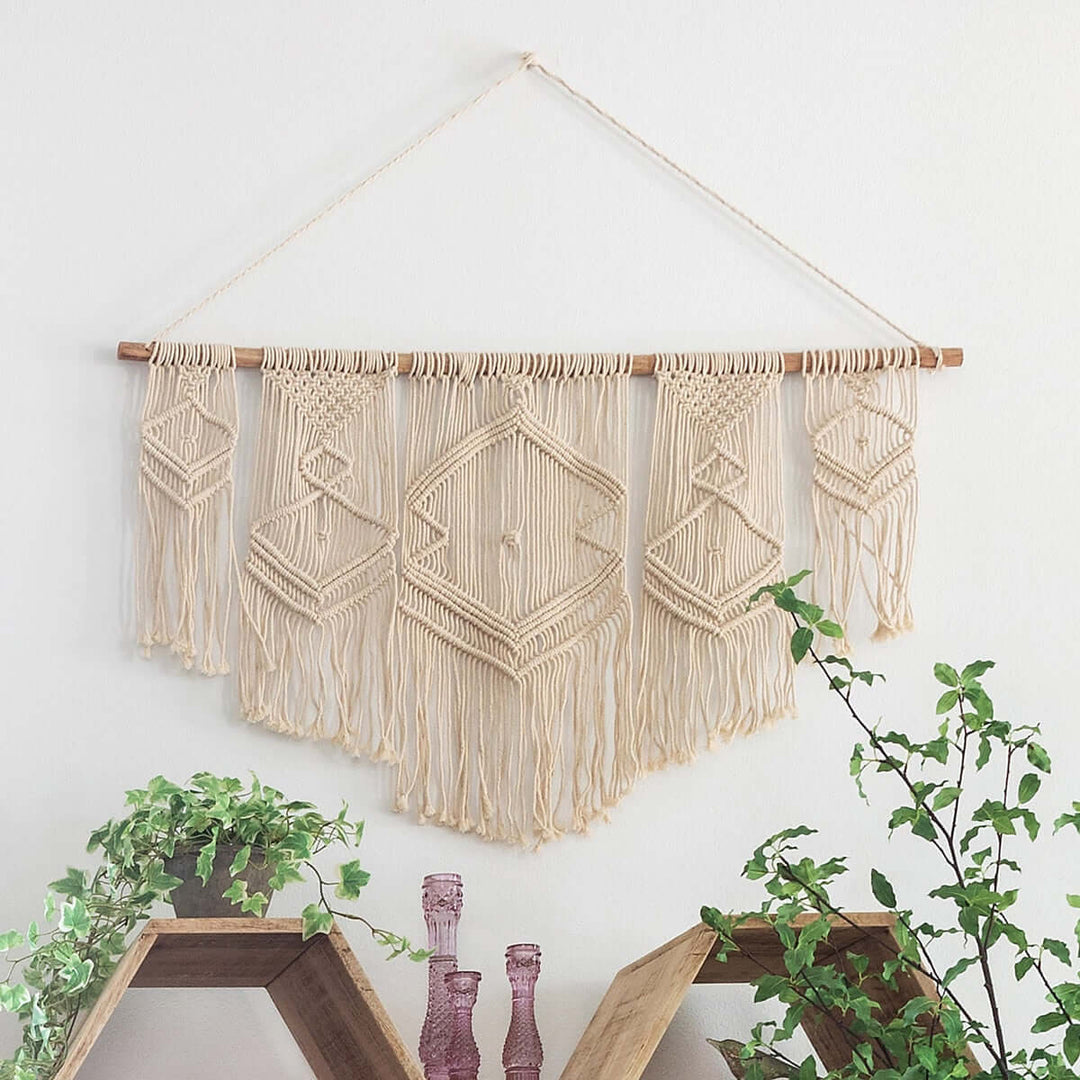 Boho Cotton Macrame Wall Hanging with intricate knots and fringes on a wooden rod, enhancing a cozy bohemian decor setting.