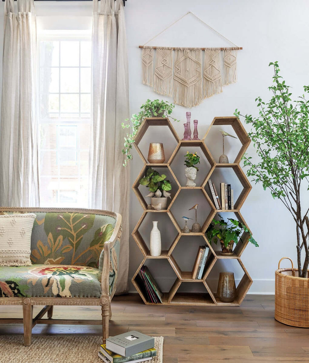 Boho Cotton Macrame Wall Hanging displayed above hexagonal wooden shelf in a brightly lit room with bohemian decor and greenery.