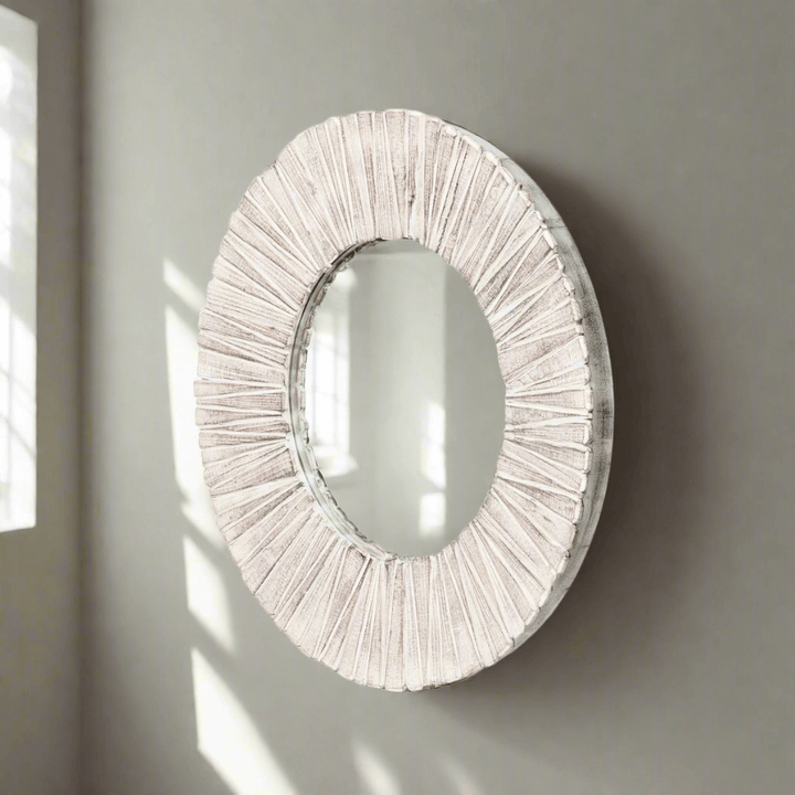 Whitewashed wood slat round wall mirror with natural texture and handcrafted design, reflecting light and elegance. Home decor.