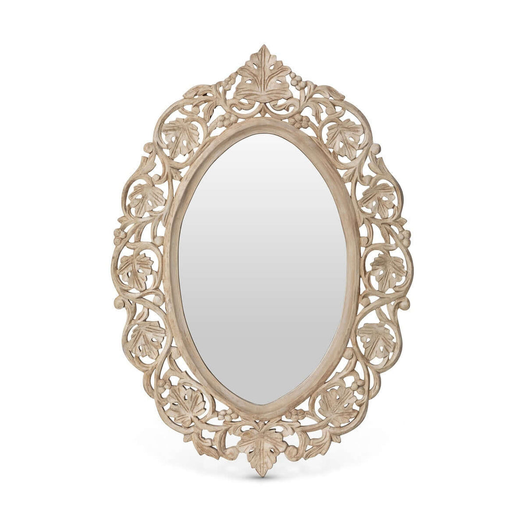 Vintage hand carved wood wall mirror with intricate floral scrollwork and oval shape, reflecting antique elegance and craftsmanship.