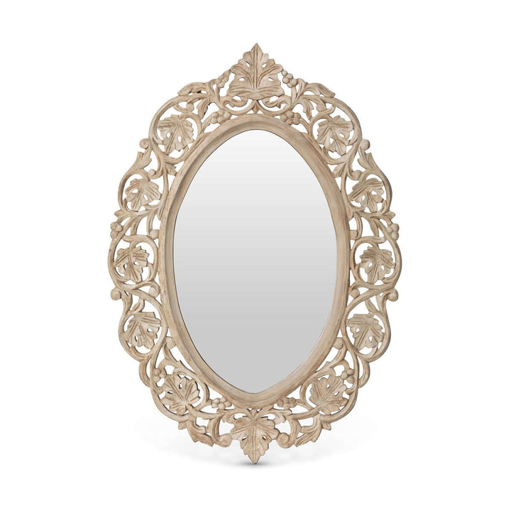 Vintage hand carved wood wall mirror with intricate floral scrollwork and oval shape, reflecting antique elegance and craftsmanship.