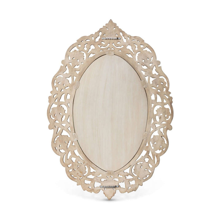 Vintage hand-carved wood wall mirror with intricate floral scrollwork and oval shape, showcasing old-world craftsmanship.
