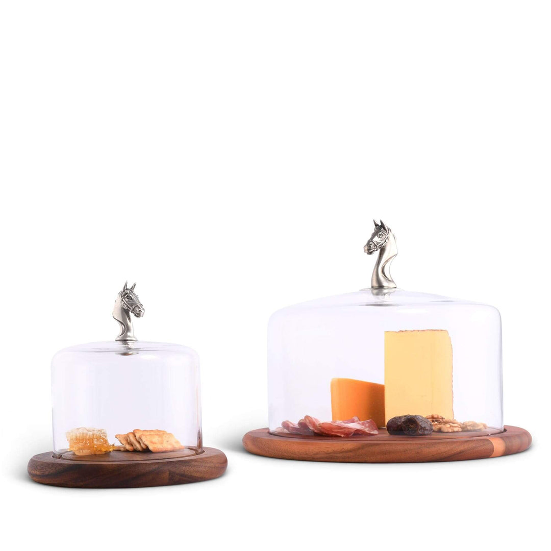 Two glass cloches with wooden bases on a white background