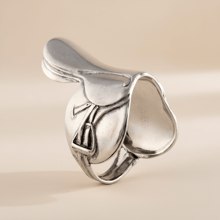 Silver saddle napkin ring on a beige background