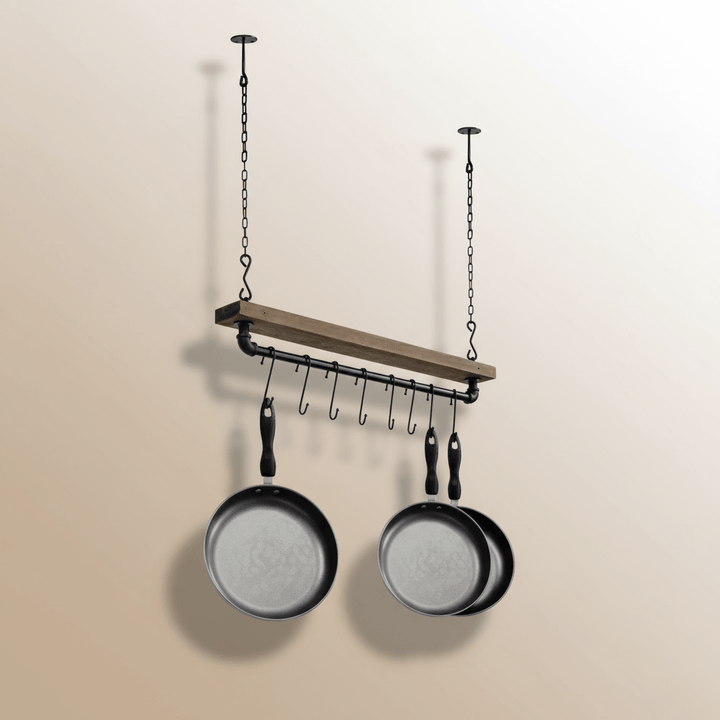 Hanging pot rack with two pans on a beige background