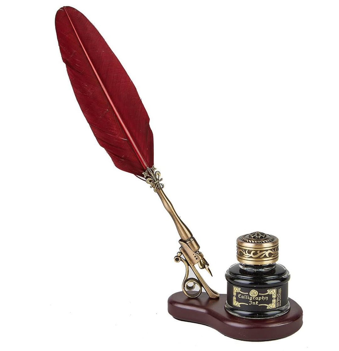 Decorative quill pen with red feather and inkwell on a white background