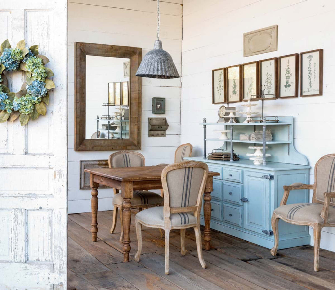 Dining room with wooden table and chairs, light blue cabinet, and decorative elements.