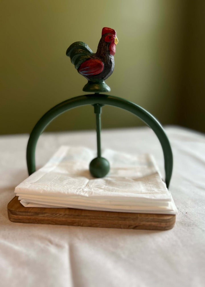 Rustic farmhouse rooster napkin holder with wooden base and metal arch, stylish for kitchen or dining decor.