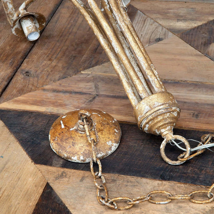 Rustic gold light fixture on a wooden surface