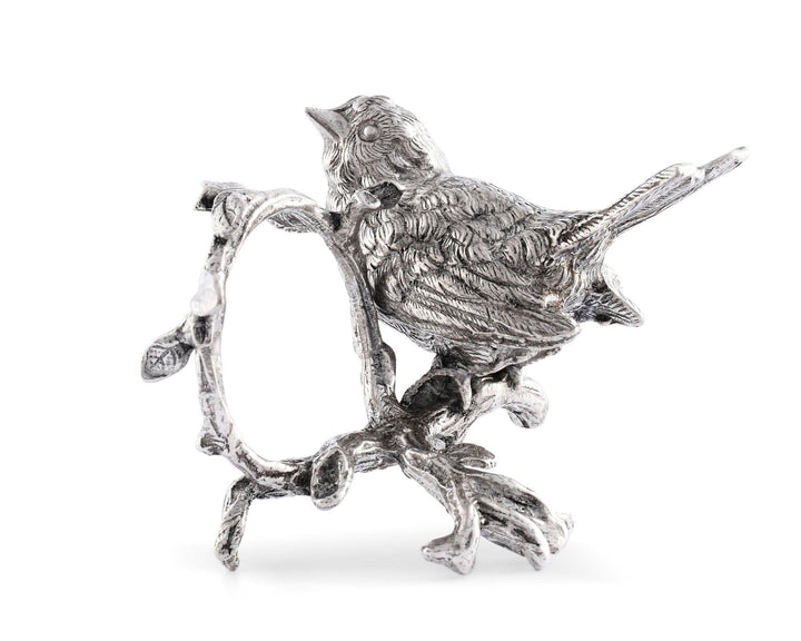 Silver bird figurine napkin holder on a branch against a white background