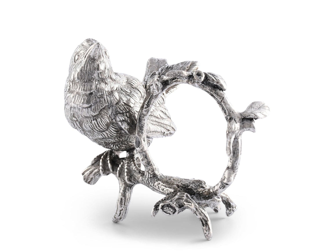 Decorative silver bird on a branch with a ring holder on a white background