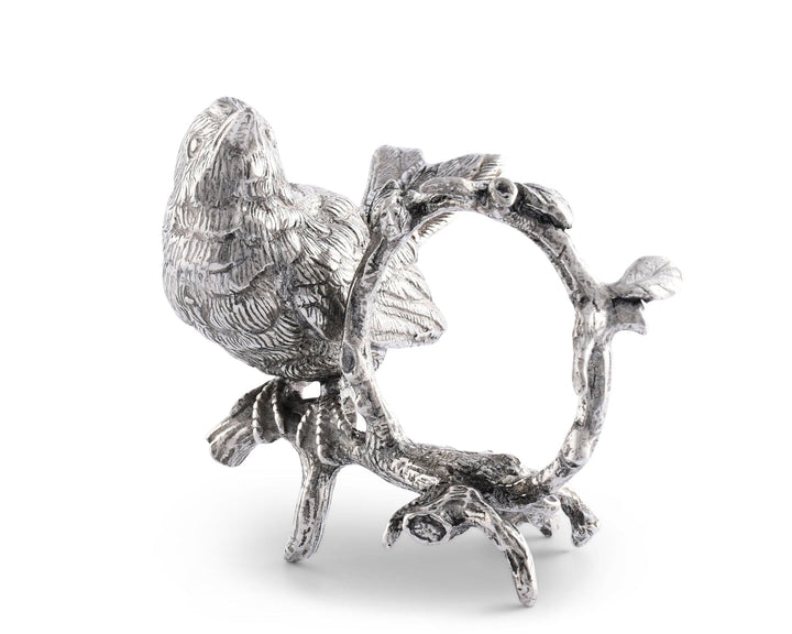 Decorative silver bird on a branch with a ring holder on a white background